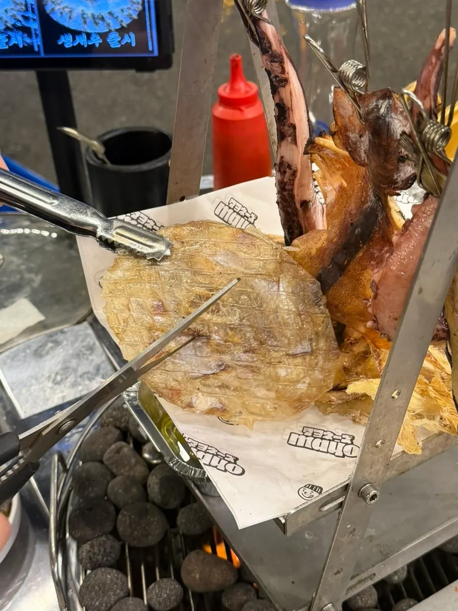 Dried seafood being grilled on the tabletop grill