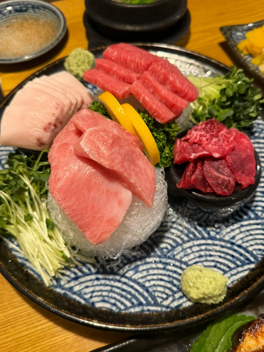 Tuna sashimi and a full spread of accompanying dishes