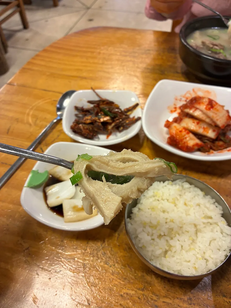 A bowl of ox head soup with milky broth