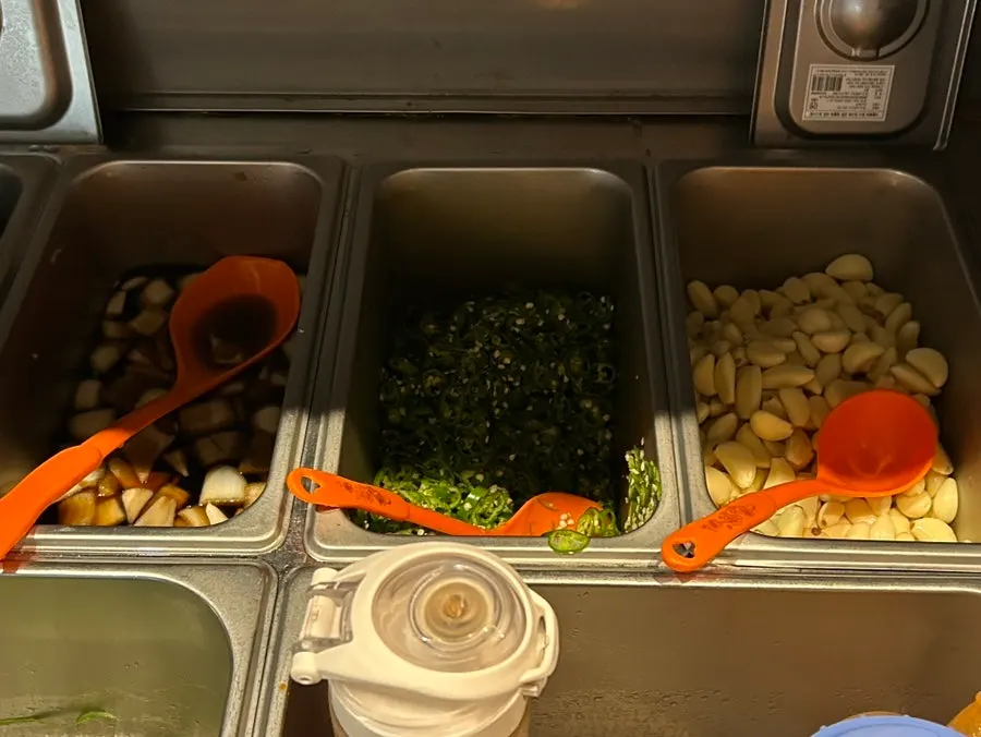 Garlic, seasoned onion, and other side dishes at the self bar