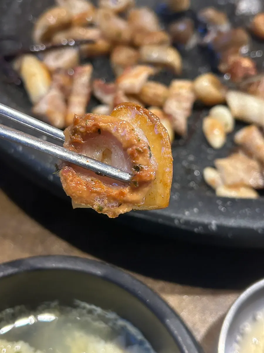 Raw makchang dipped in seasoned sauce