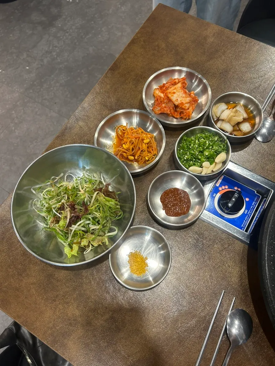 Interior seating at Bongja Makchang filled with four-person tables