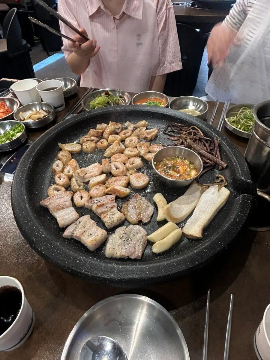 Makchang and pork belly cooking on the grill