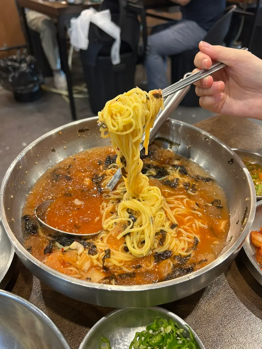 A generously portioned bowl of kimchi noodle soup