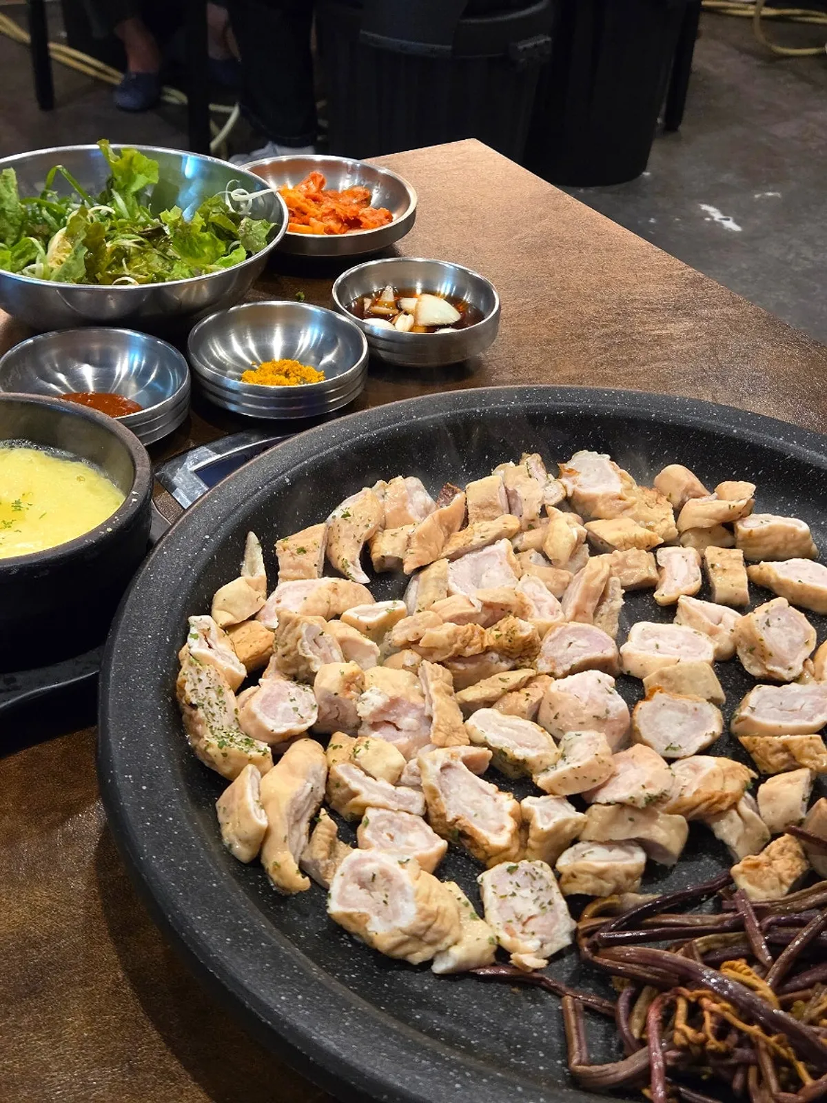 Two plates of raw makchang from the Bongja set on the grill table
