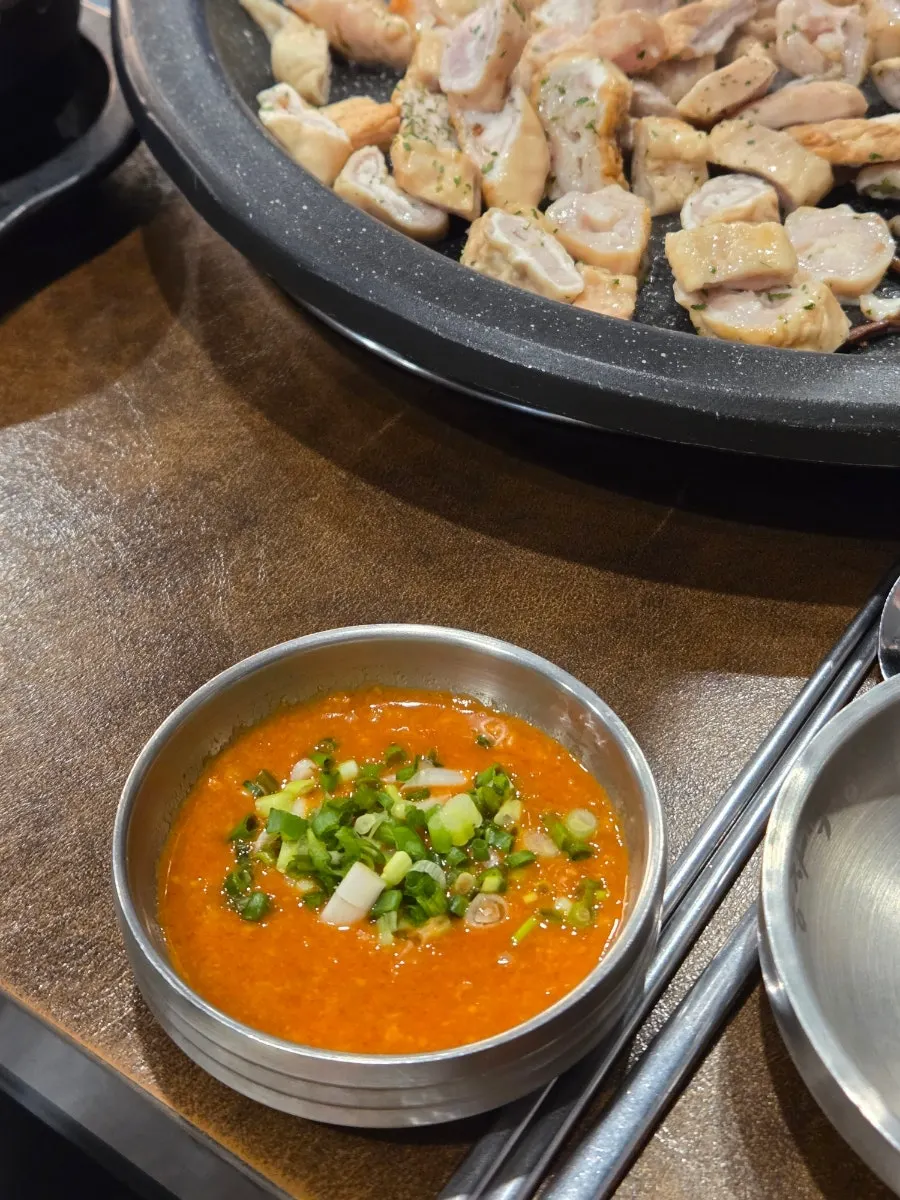 Full spread of side dishes including fresh kimchi and steamed egg
