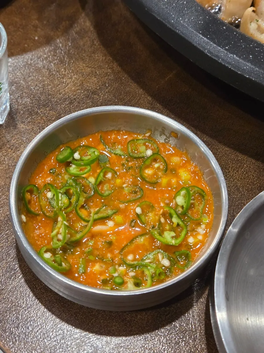Close-up of Bongja Makchang's basic side dishes and steamed egg