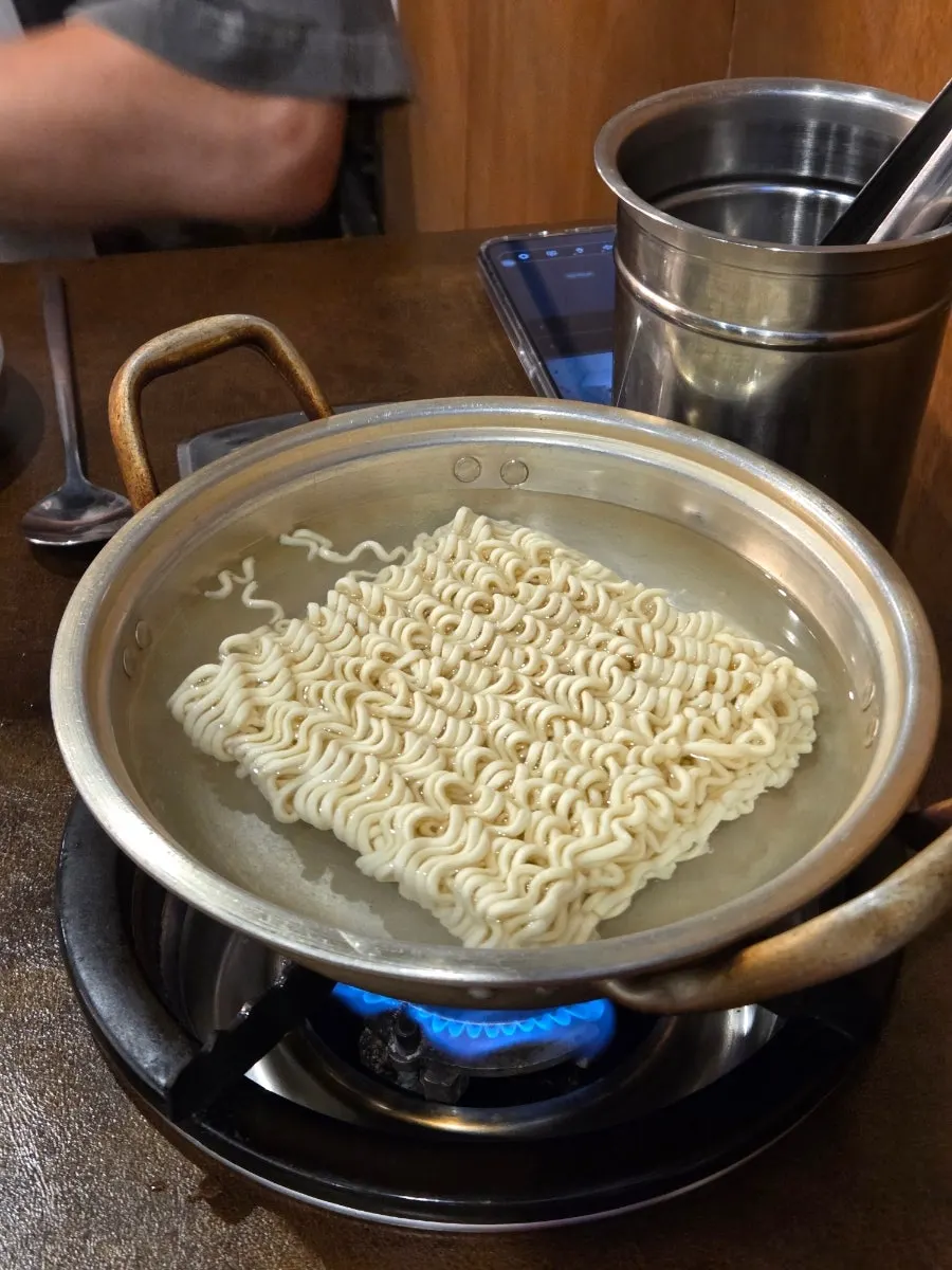 Jjambbong ramen boiling on the table burner