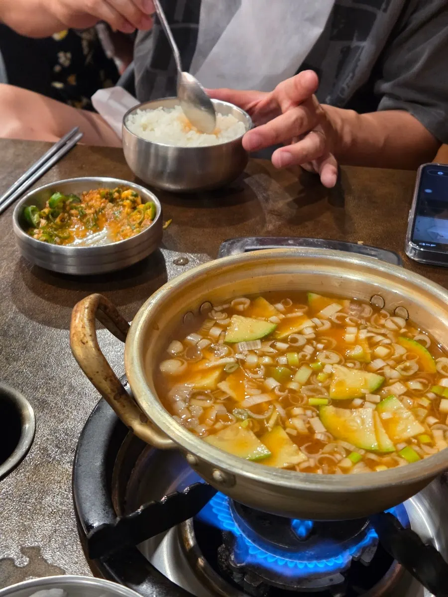 A lettuce wrap filled with makchang and side dishes