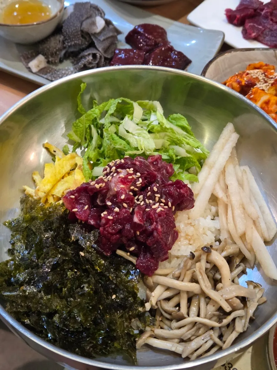 Yukhoe bibimbap topped with raw beef