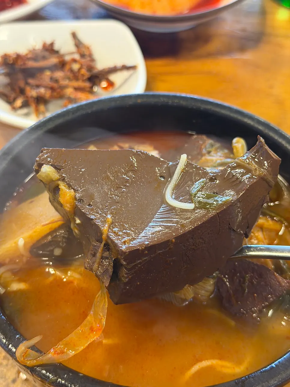 Hot pot bowl of special ttaro-gukbap topped with minced garlic