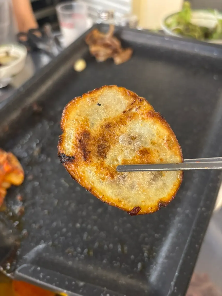 Kimchi, potatoes, and mushrooms grilling together