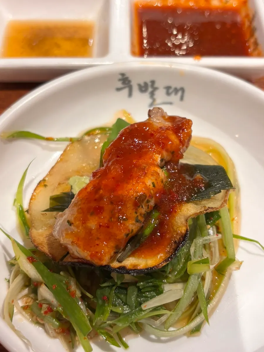 Jjageuli kimchi and pork belly accompaniments
