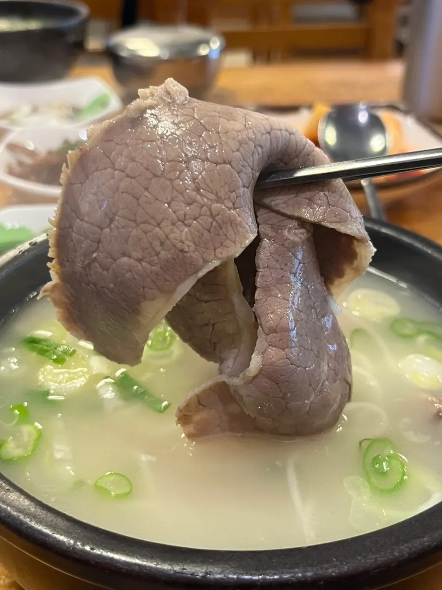 Close-up of yangtang broth and solid pieces