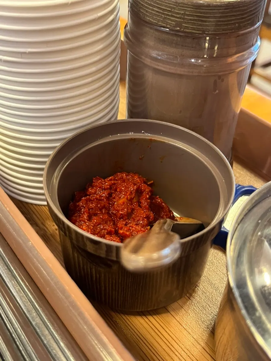 Lifting thin noodles out of the broth