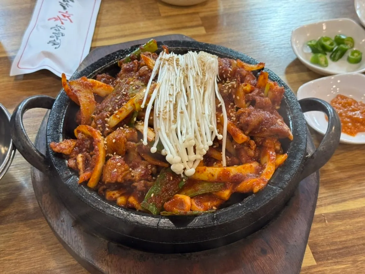 Fire-grilled squid and pork stir-fry served on a hot stone plate