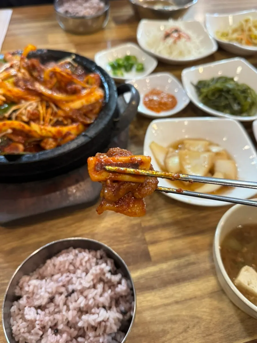 A generous meal spread with fire-grilled squid and pork
