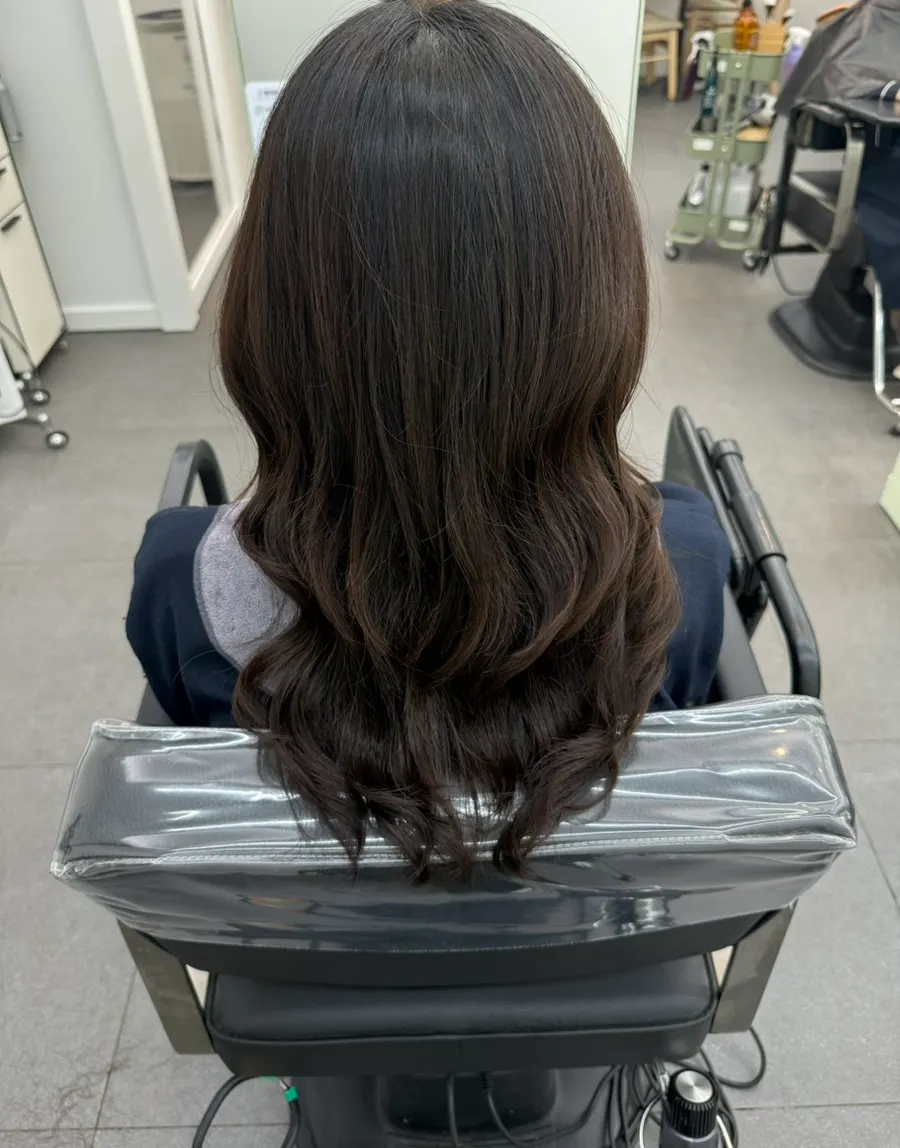 Layered perm finished with calm, soft curls