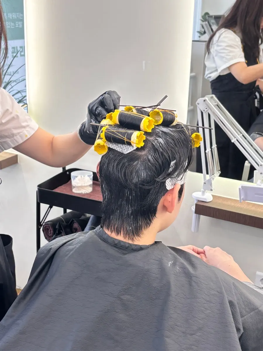 Moving to the shampoo room after the perm service