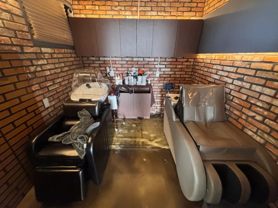 Shampoo area with red brick and soft lighting