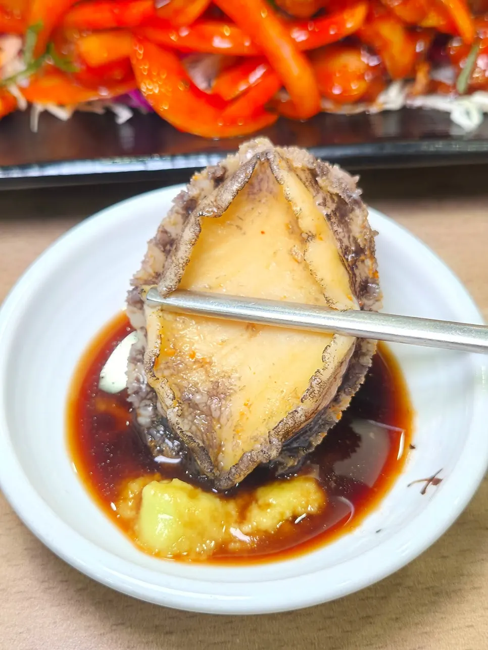 Thick abalone meat dipped in wasabi soy sauce