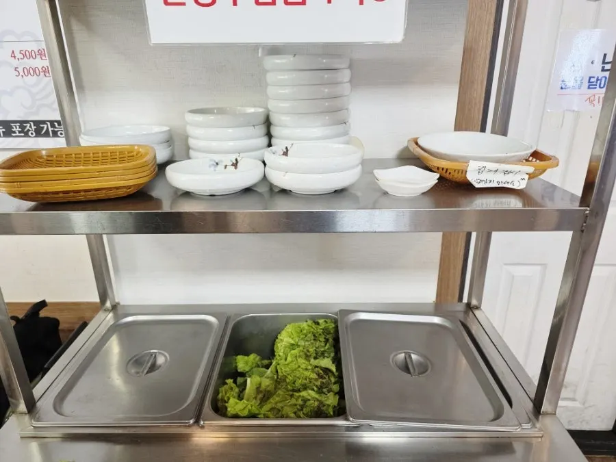 Self-service bar with lettuce and extra dishes