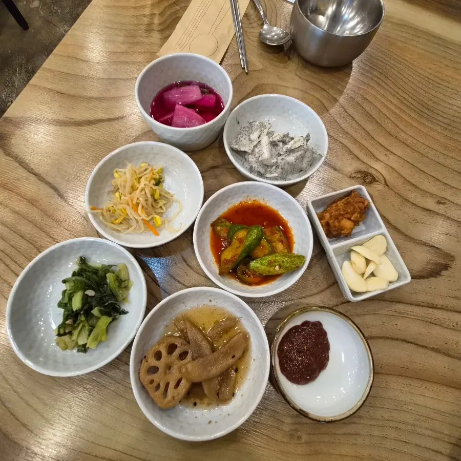 Table set with grilled bulgogi, mackerel, and stone-pot rice