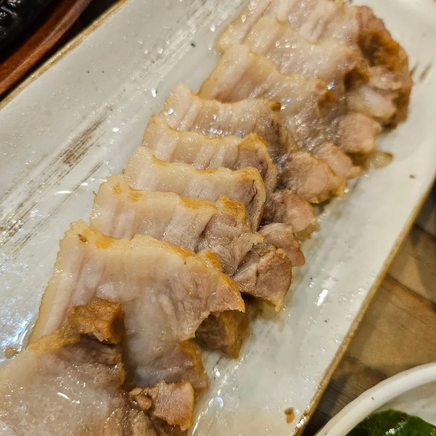 Snail ssamjang and herbal boiled pork table setting