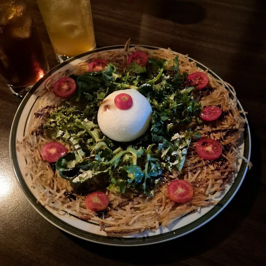 Crispy shredded potato pancake topped with salad