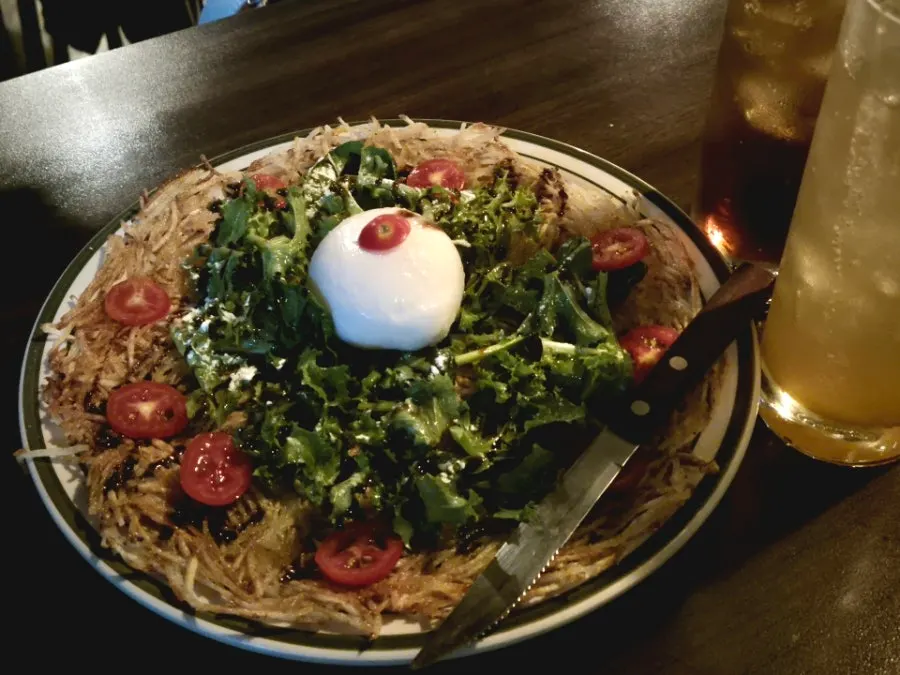 Crispy shredded potato pancake before cutting with scissors