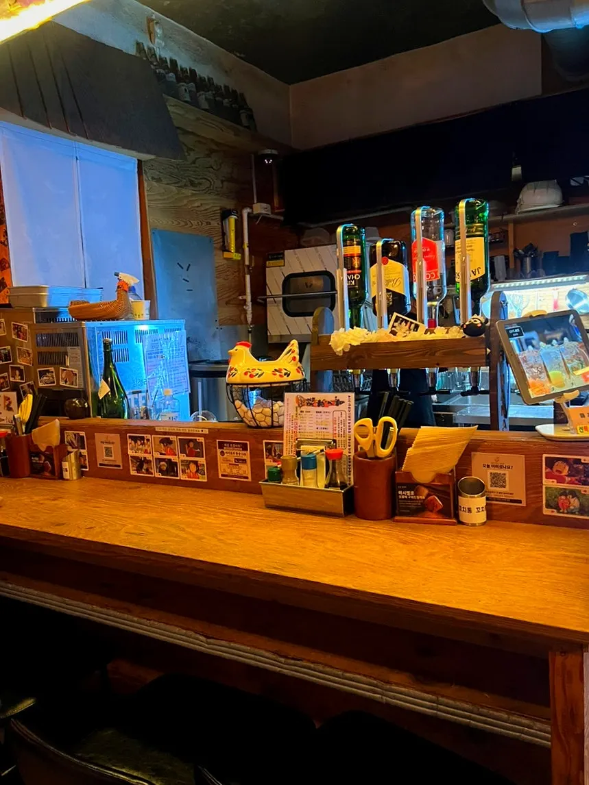 Cozy interior lit with yellow light and the open kitchen visible