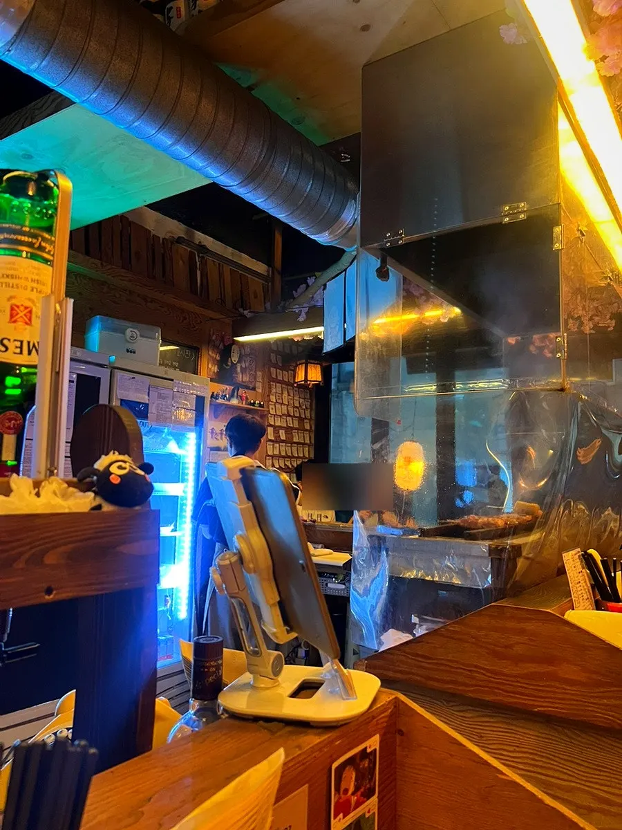 View of the dachi seats with skewers being grilled in sight