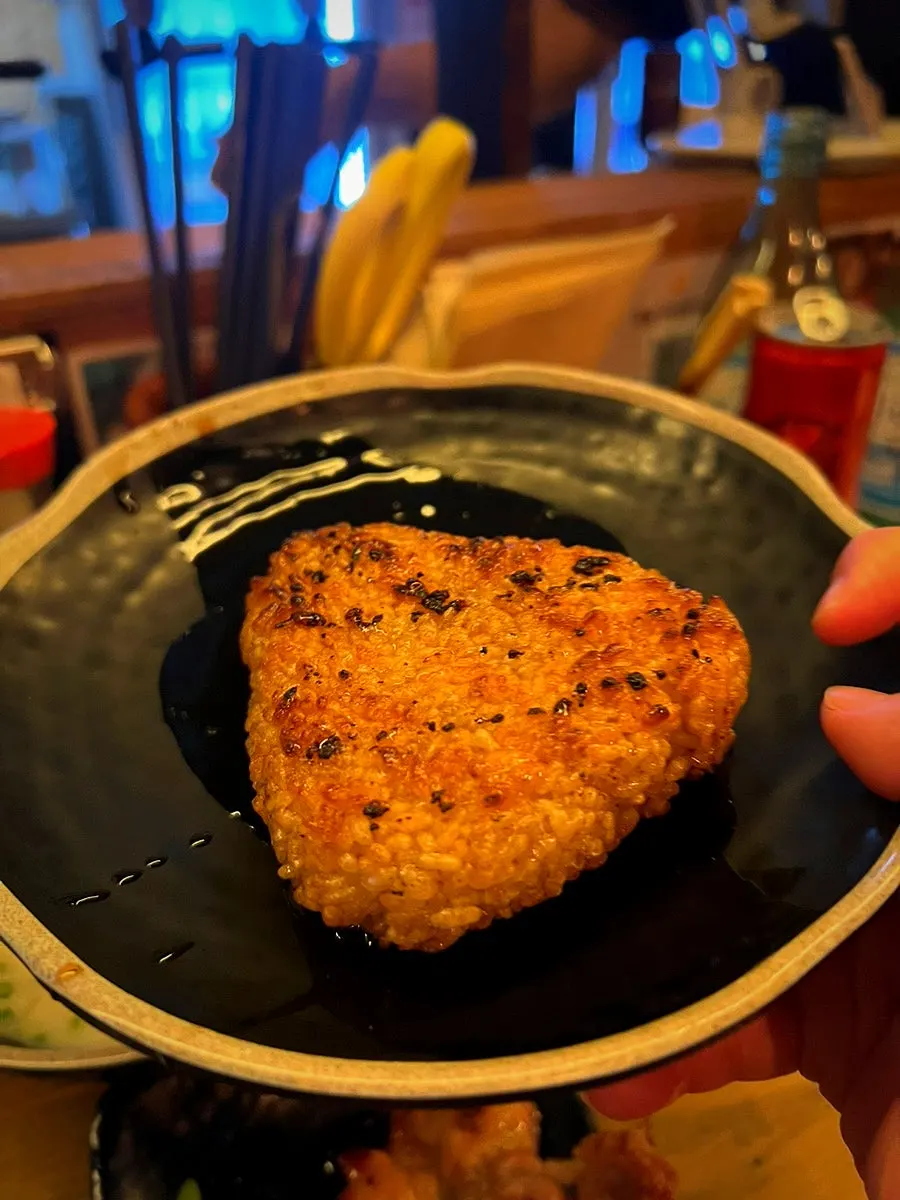 A soju shot alongside the skewers