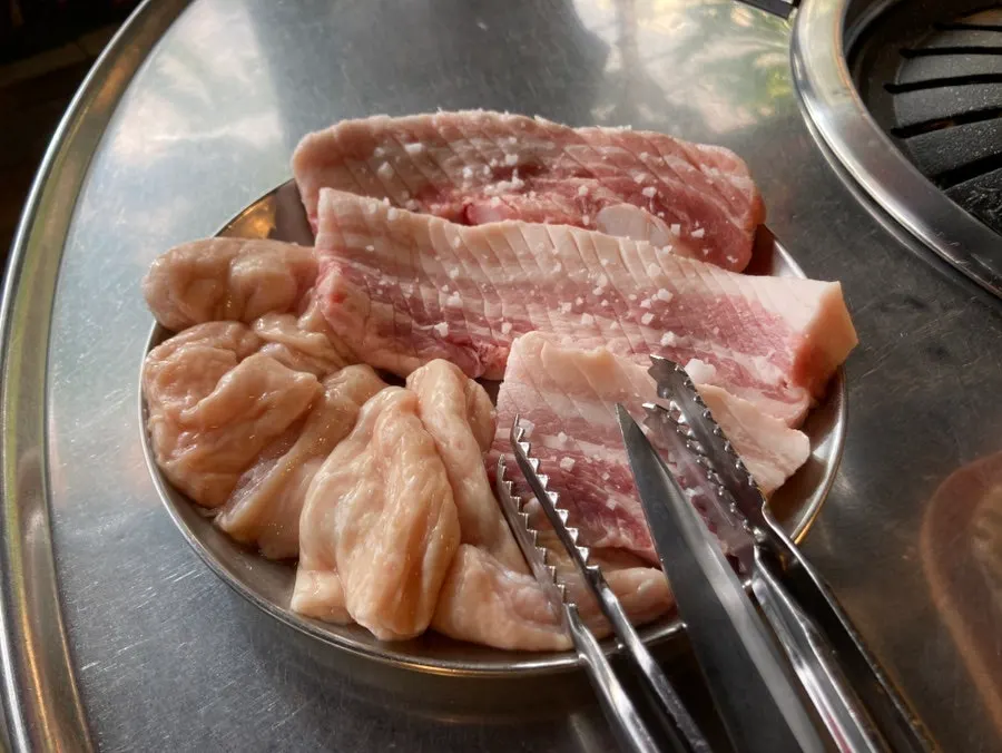 Two servings of thick pork belly sprinkled with coarse salt
