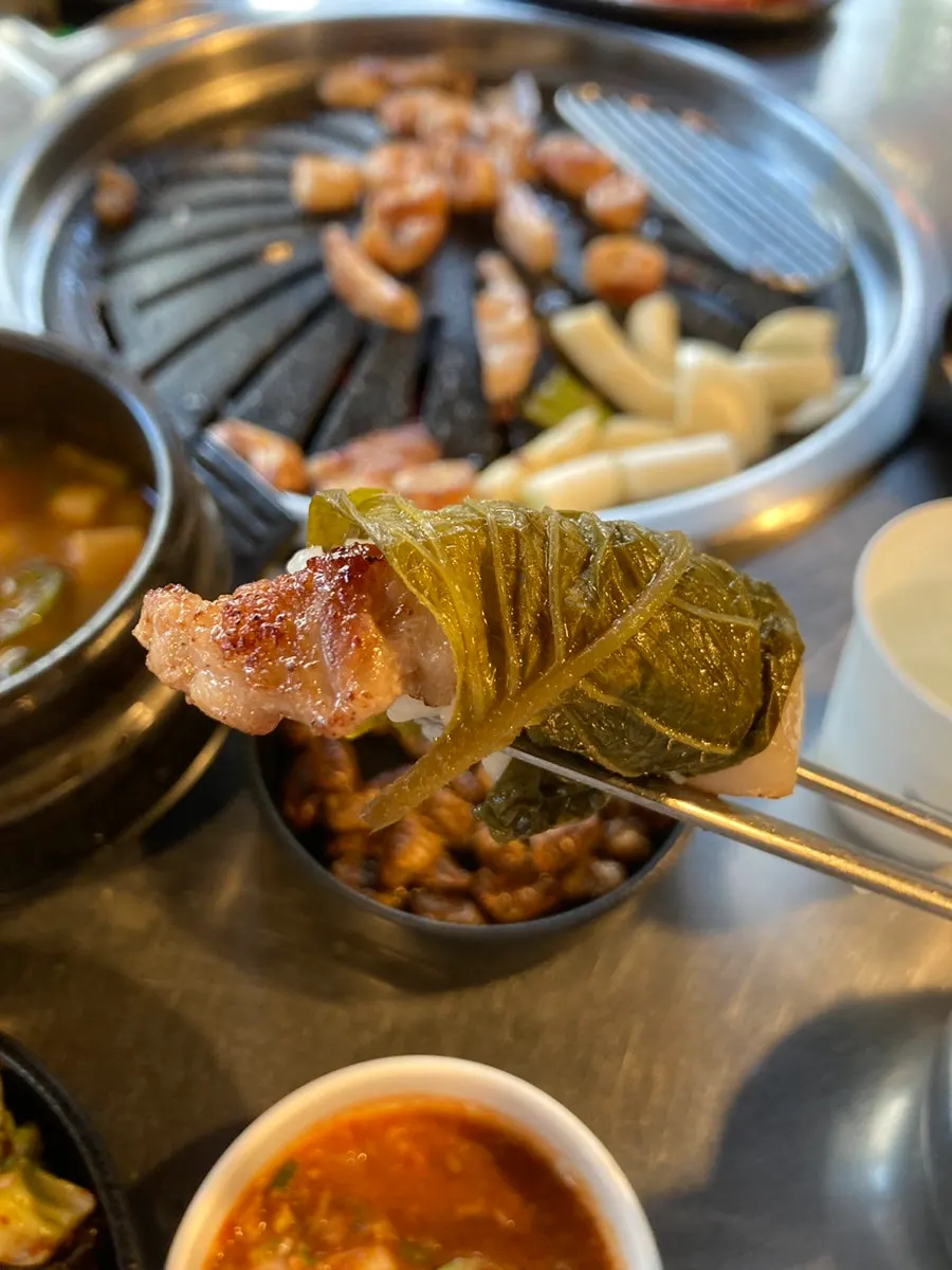 Raw makchang slowly cooking on the grill