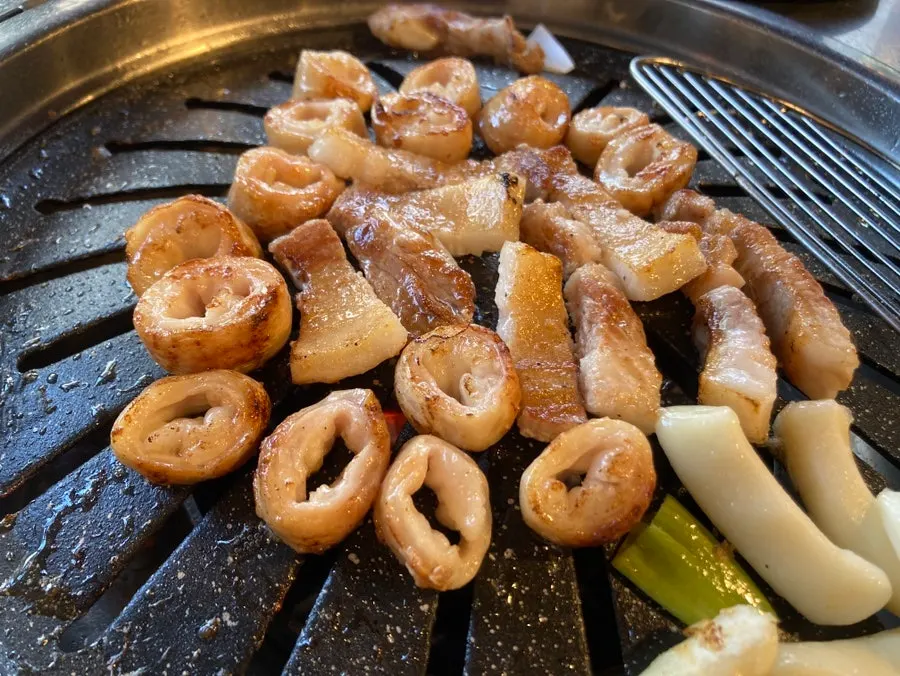 Close-up of golden-brown makchang on the grill