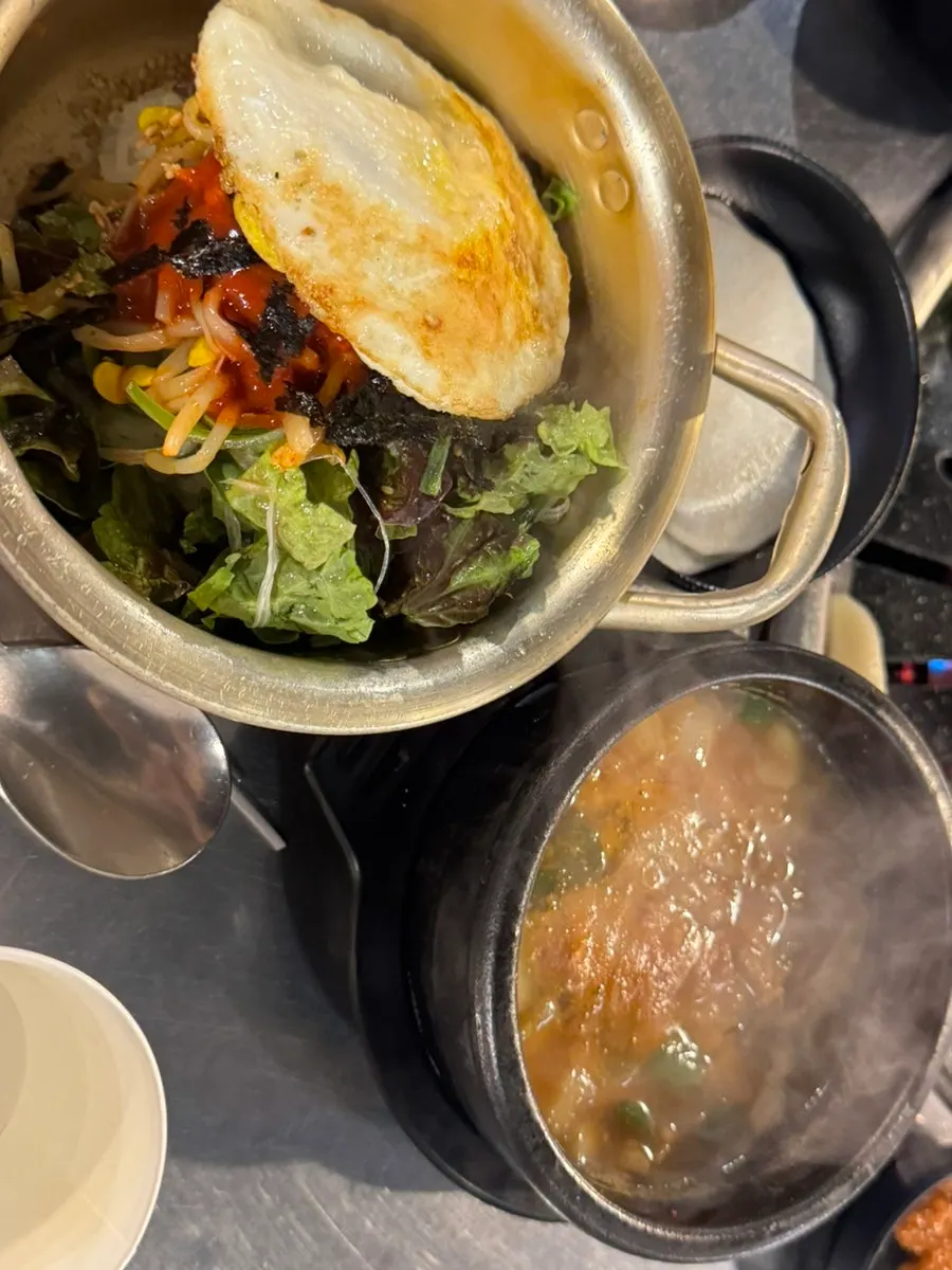 Table spread with bibimbap and makchang together