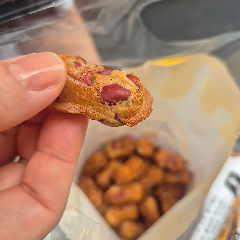 Peanut bread split in half showing whole peanuts inside