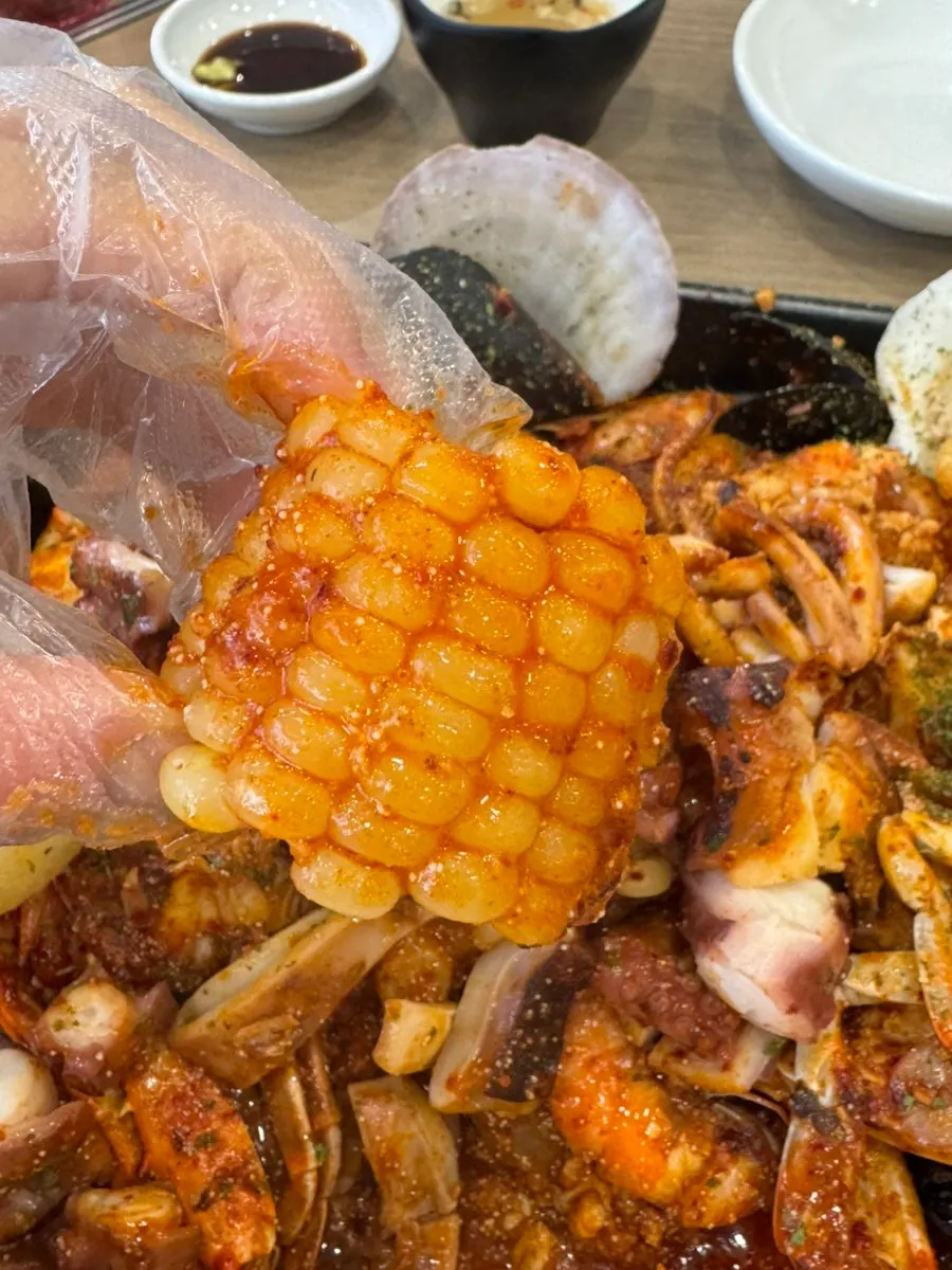 A spoonful of white rice topped with roe and squid