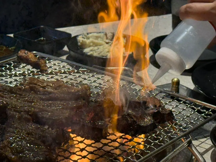 Seasoned pork ribs grilling on the pan