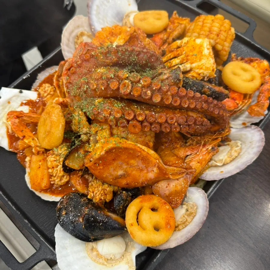 Menu board listing seafood boil and seafood hot pot