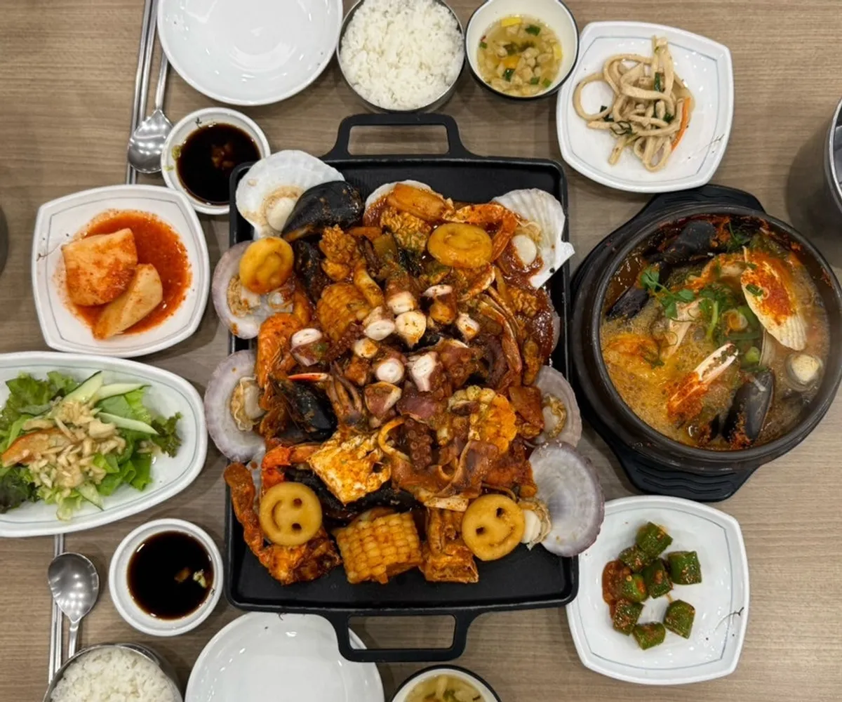 Table set for two with both the seafood boil and seafood hot pot