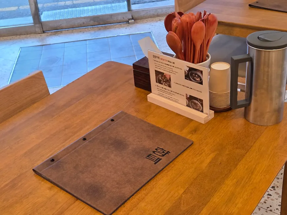 Wood-toned table seating inside the restaurant