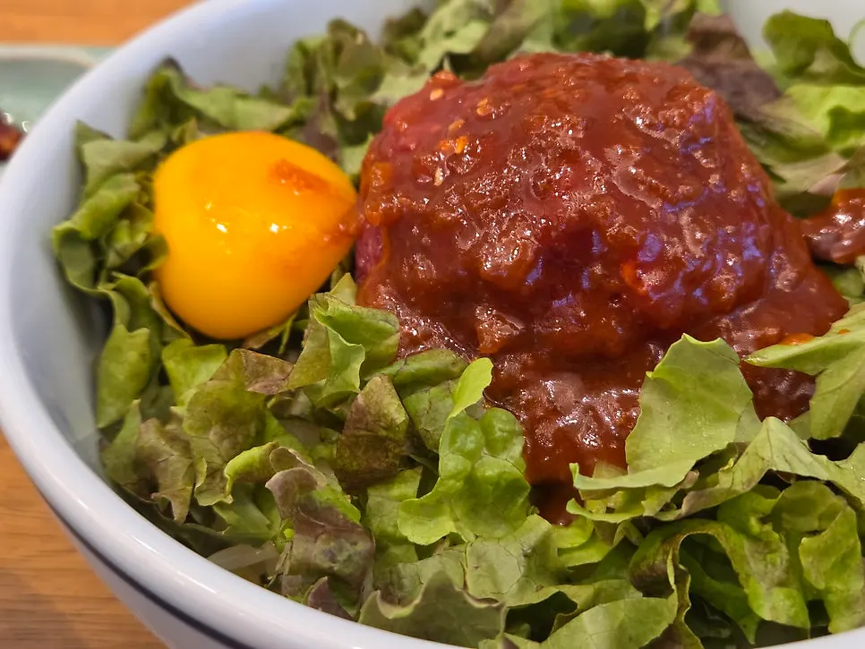 Yukhoe bibimbap with egg yolk and sauce