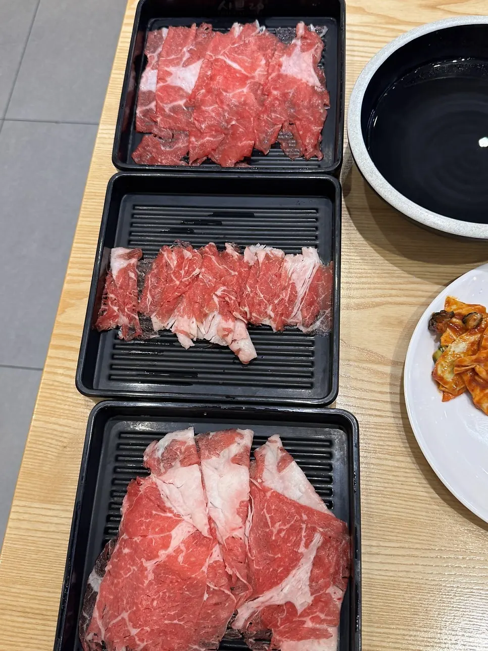 Thinly sliced shabu-shabu meat brought back on a tray