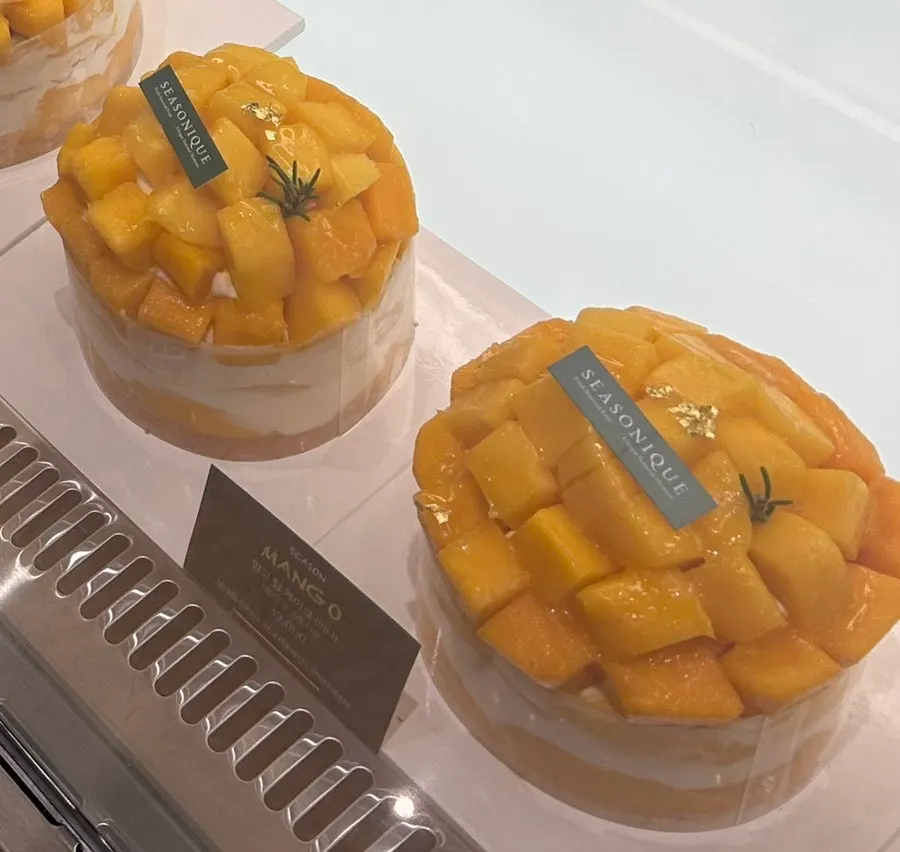Mango Tower Cake mini topped with 3 whole mangoes