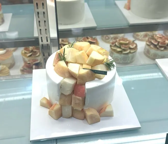 Close-up of a Siznique cake piled high with mango