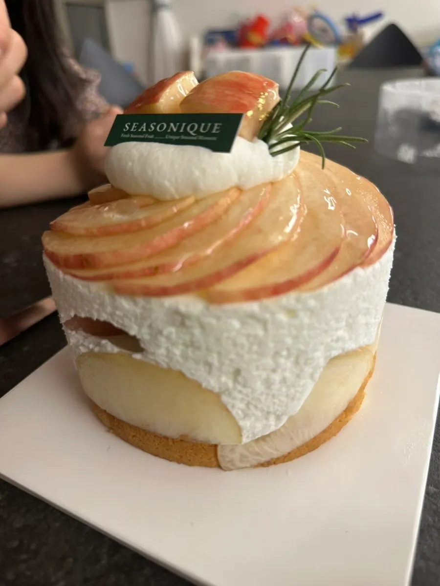 Peach cake with a heart-shaped candle inserted