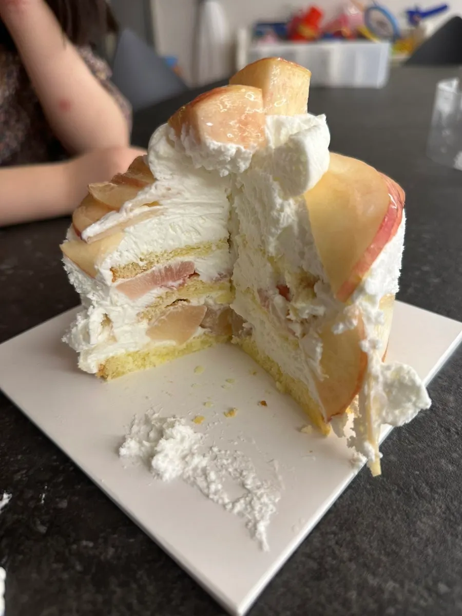 Cross-section of the sliced peach cake with milk cream