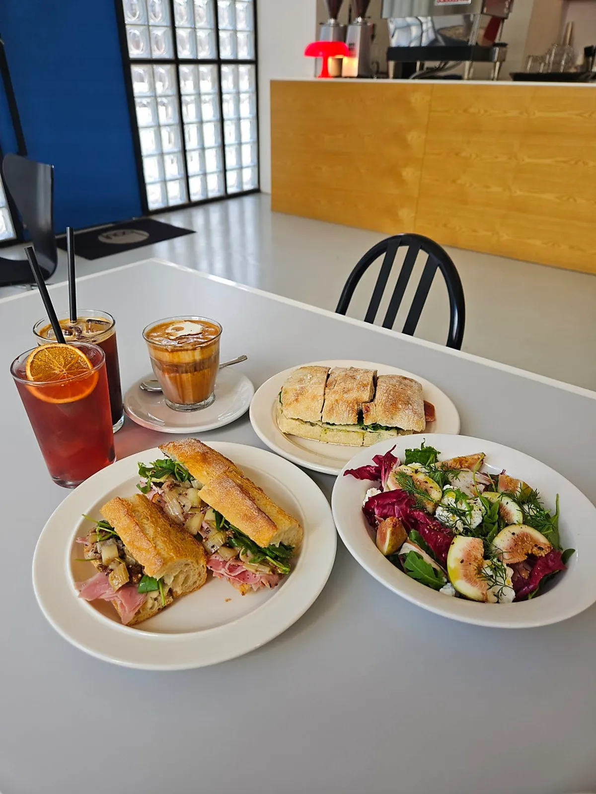 Table setting of sandwiches and salad at Baut